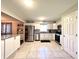 Bright, white kitchen featuring stainless steel appliances, granite countertops, and tile flooring at 2892 S State Road 267, Plainfield, IN 46168