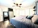Comfortable bedroom with hardwood floors, ceiling fan, and large bed at 2892 S State Road 267, Plainfield, IN 46168