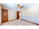 Spacious bedroom with ceiling fan and door to hallway at 4738 Moss Creek Ct, Indianapolis, IN 46237