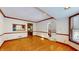 Spacious dining room featuring hardwood floors and views into kitchen and living room at 4738 Moss Creek Ct, Indianapolis, IN 46237
