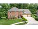 Two-story brick home with a three-car garage and lush landscaping at 4738 Moss Creek Ct, Indianapolis, IN 46237