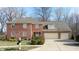 Two-story brick home with a three-car garage and well-maintained lawn at 4738 Moss Creek Ct, Indianapolis, IN 46237