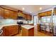 Oak kitchen with stainless steel appliances and breakfast bar at 4738 Moss Creek Ct, Indianapolis, IN 46237