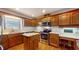 Kitchen with oak cabinets, stainless steel appliances, and an island at 4738 Moss Creek Ct, Indianapolis, IN 46237