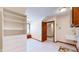 Bright laundry room with built-in shelving and a utility sink at 4738 Moss Creek Ct, Indianapolis, IN 46237