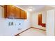 Functional laundry room with wood cabinets and shelving at 4738 Moss Creek Ct, Indianapolis, IN 46237