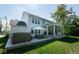 Beautiful backyard showcasing the home's exterior, a spacious patio, hot tub and well-maintained lawn at 8722 Rockwood Ln, Indianapolis, IN 46259