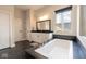 Bathroom featuring a soaking tub, a modern vanity, and ample natural light for a spa-like experience at 8722 Rockwood Ln, Indianapolis, IN 46259