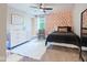 Comfortable bedroom with a cozy rug, unique wall décor, and a ceiling fan at 8722 Rockwood Ln, Indianapolis, IN 46259