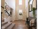 Bright foyer with a soaring ceiling, white door, and a staircase on the left side at 8722 Rockwood Ln, Indianapolis, IN 46259