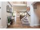 Spacious foyer with an open view of the home, a staircase on the right and a decorative bench at 8722 Rockwood Ln, Indianapolis, IN 46259