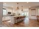 Open kitchen with a large island, seating for four, white cabinets, and stainless steel appliances at 8722 Rockwood Ln, Indianapolis, IN 46259