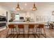 Stylish kitchen with a large center island, quartz countertops, and modern pendant lighting at 8722 Rockwood Ln, Indianapolis, IN 46259
