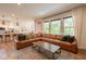 Inviting living room with a large leather sectional sofa and lots of natural light at 8722 Rockwood Ln, Indianapolis, IN 46259