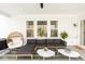 Charming covered patio with cozy seating, views to the backyard, and contemporary design elements at 8722 Rockwood Ln, Indianapolis, IN 46259