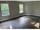 Bright bedroom featuring two windows, grey walls, and dark laminate wood flooring at 17902 Cristin Way, Westfield, IN 46062