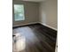 Bedroom with grey walls and dark laminate wood flooring and a large window at 17902 Cristin Way, Westfield, IN 46062