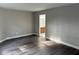 Bedroom with gray walls, laminate wood flooring, and a view to the bathroom at 17902 Cristin Way, Westfield, IN 46062