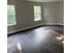 Spacious room with wood-look floors, two windows offering natural light, and neutral walls at 17902 Cristin Way, Westfield, IN 46062