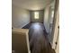 Hallway with wood-look flooring and a view of a window at the end of the hall at 17902 Cristin Way, Westfield, IN 46062