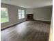 Living room with a fireplace and two windows showing the front yard at 17902 Cristin Way, Westfield, IN 46062