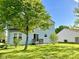 Green backyard with a light blue sided home with a small deck at 1327 Blue Ridge Ln, Brownsburg, IN 46112
