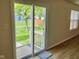 A sliding glass door and view of backyard with well-maintained lawn and wood fence at 1327 Blue Ridge Ln, Brownsburg, IN 46112