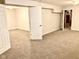 Spacious carpeted basement area with access to utility room and door to additional living space at 1327 Blue Ridge Ln, Brownsburg, IN 46112