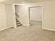 Finished basement area featuring new carpeting and stairway to main level at 1327 Blue Ridge Ln, Brownsburg, IN 46112