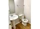 The bathroom features a pedestal sink, toilet, and light vinyl floors at 1327 Blue Ridge Ln, Brownsburg, IN 46112