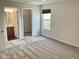 Carpeted bedroom with attached bathroom and walk-in closet and large window at 1327 Blue Ridge Ln, Brownsburg, IN 46112