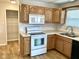 Kitchen featuring ample wooden cabinetry, modern appliances, and a view into pantry at 1327 Blue Ridge Ln, Brownsburg, IN 46112