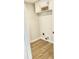 Bright laundry room with wood-look flooring and white cabinets ready for personalization at 1327 Blue Ridge Ln, Brownsburg, IN 46112
