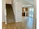 Living room with adjacent stairway leading to kitchen with wood cabinets and stainless appliances at 1327 Blue Ridge Ln, Brownsburg, IN 46112