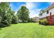 Large backyard with lush green lawn and mature trees, offering a serene and private outdoor space at 8819 Anchor Bay Ct, Indianapolis, IN 46236