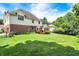Expansive backyard featuring lush green grass, a deck, and mature trees providing shade and privacy at 8819 Anchor Bay Ct, Indianapolis, IN 46236
