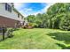 Large backyard with well-maintained lawn, mature trees, and a fenced perimeter at 8819 Anchor Bay Ct, Indianapolis, IN 46236