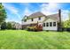 Lush backyard with manicured lawn, patio, and partial view of home with brick accents at 8819 Anchor Bay Ct, Indianapolis, IN 46236
