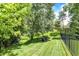 Serene backyard setting with mature trees and space for seating, perfect for relaxation and privacy at 8819 Anchor Bay Ct, Indianapolis, IN 46236