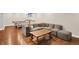 Finished basement features recessed lighting, ping pong table, wet bar, and comfortable gray sectional sofa at 8819 Anchor Bay Ct, Indianapolis, IN 46236