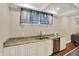 Basement wet bar features granite countertops, stainless steel dishwasher, and white cabinets at 8819 Anchor Bay Ct, Indianapolis, IN 46236