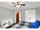 Bedroom with ceiling fan, barn door to walk-in closet, and view of closet organizer at 8819 Anchor Bay Ct, Indianapolis, IN 46236