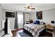 Well-lit bedroom featuring ceiling fan, a window view and decoratively themed artwork at 8819 Anchor Bay Ct, Indianapolis, IN 46236