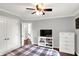 Spacious bedroom with ceiling fan, TV, a full dresser and double door closet at 8819 Anchor Bay Ct, Indianapolis, IN 46236