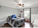 Cozy bedroom with a ceiling fan, plaid comforter, and natural light from a window at 8819 Anchor Bay Ct, Indianapolis, IN 46236