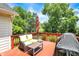 Outdoor deck with red wood flooring, and a seating area with a grill at 8819 Anchor Bay Ct, Indianapolis, IN 46236