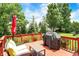 Outdoor deck with red wood flooring, seating area, and grill perfect for entertaining at 8819 Anchor Bay Ct, Indianapolis, IN 46236
