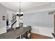 Charming dining room with wood floors, neutral decor, and modern chandelier at 8819 Anchor Bay Ct, Indianapolis, IN 46236