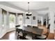 Inviting dining area with large windows, hardwood floors, and stylish light fixture at 8819 Anchor Bay Ct, Indianapolis, IN 46236