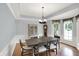 Bright dining room featuring wainscoting, hardwood floors, and elegant chandelier at 8819 Anchor Bay Ct, Indianapolis, IN 46236